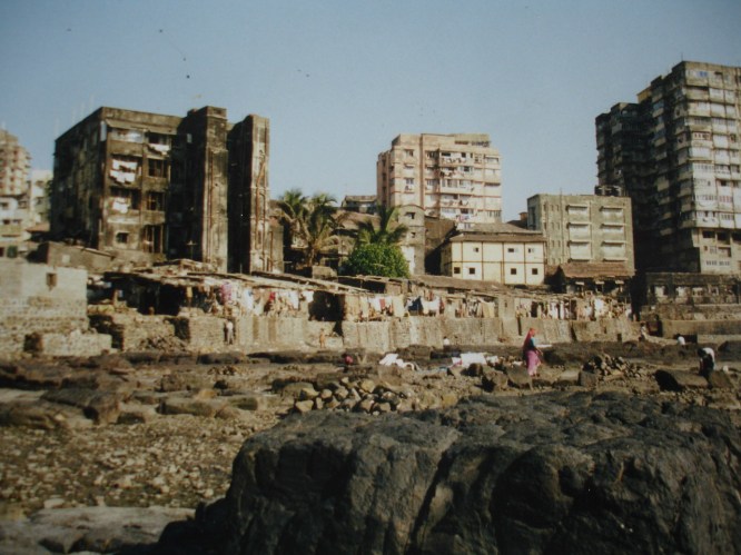 A toxic reality where many people live, in the lanes off the streets. Make shift shelters on a rocky toxic beach.